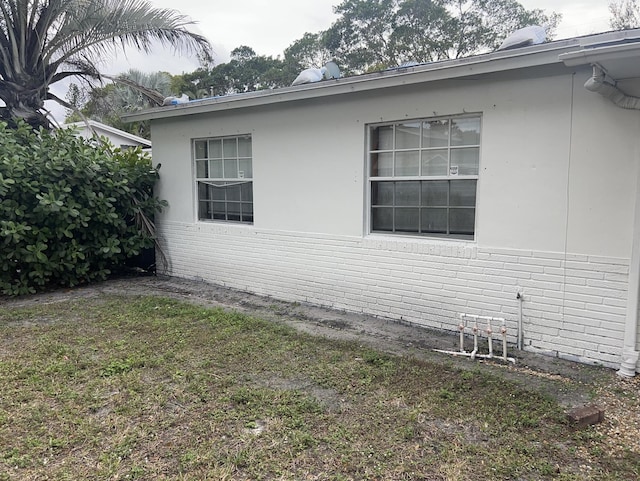 view of property exterior with a lawn