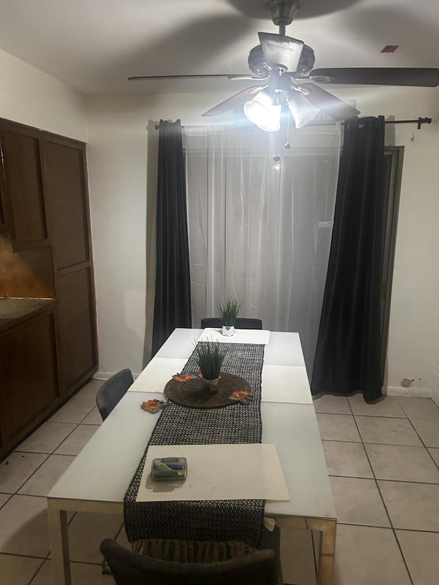 tiled dining area with ceiling fan