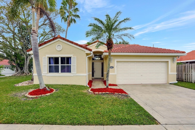 mediterranean / spanish home with a garage and a front yard