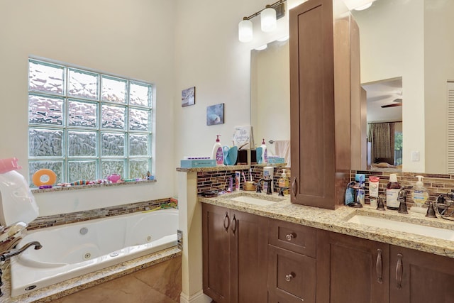 bathroom featuring vanity and tiled tub