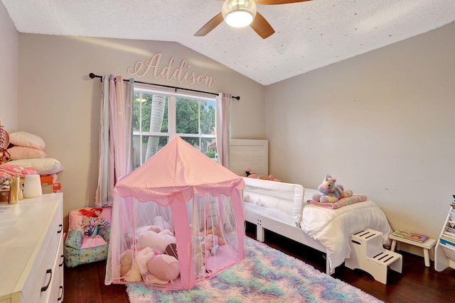 bedroom featuring lofted ceiling, a textured ceiling, dark hardwood / wood-style flooring, and ceiling fan