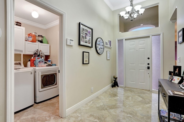 foyer featuring crown molding, washing machine and clothes dryer, and an inviting chandelier