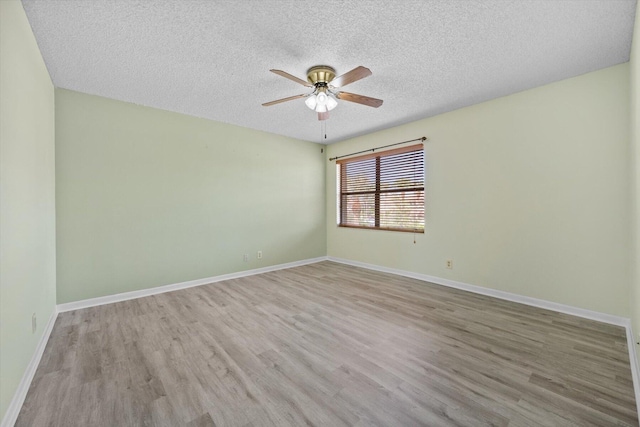 empty room with ceiling fan, a textured ceiling, and light hardwood / wood-style floors