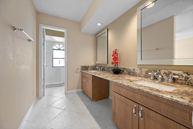 bathroom featuring vanity, tile patterned flooring, and a textured ceiling