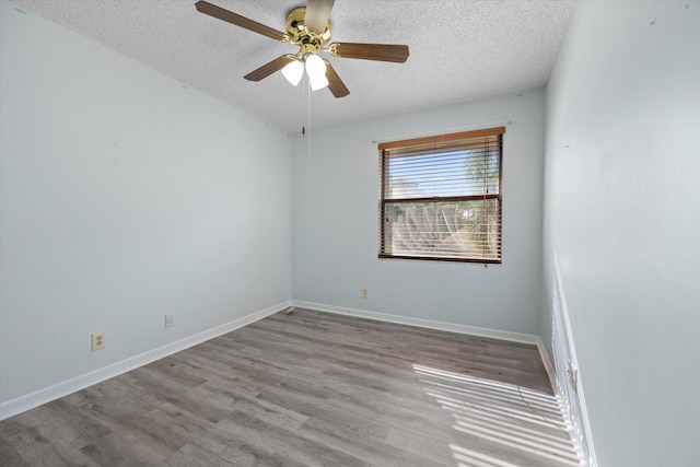 empty room featuring ceiling fan, light hardwood / wood-style floors, and a textured ceiling