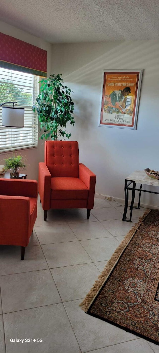 interior space with tile patterned floors and a textured ceiling