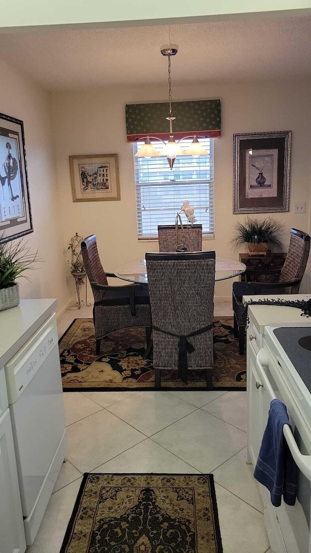 dining space with light tile patterned floors and a textured ceiling