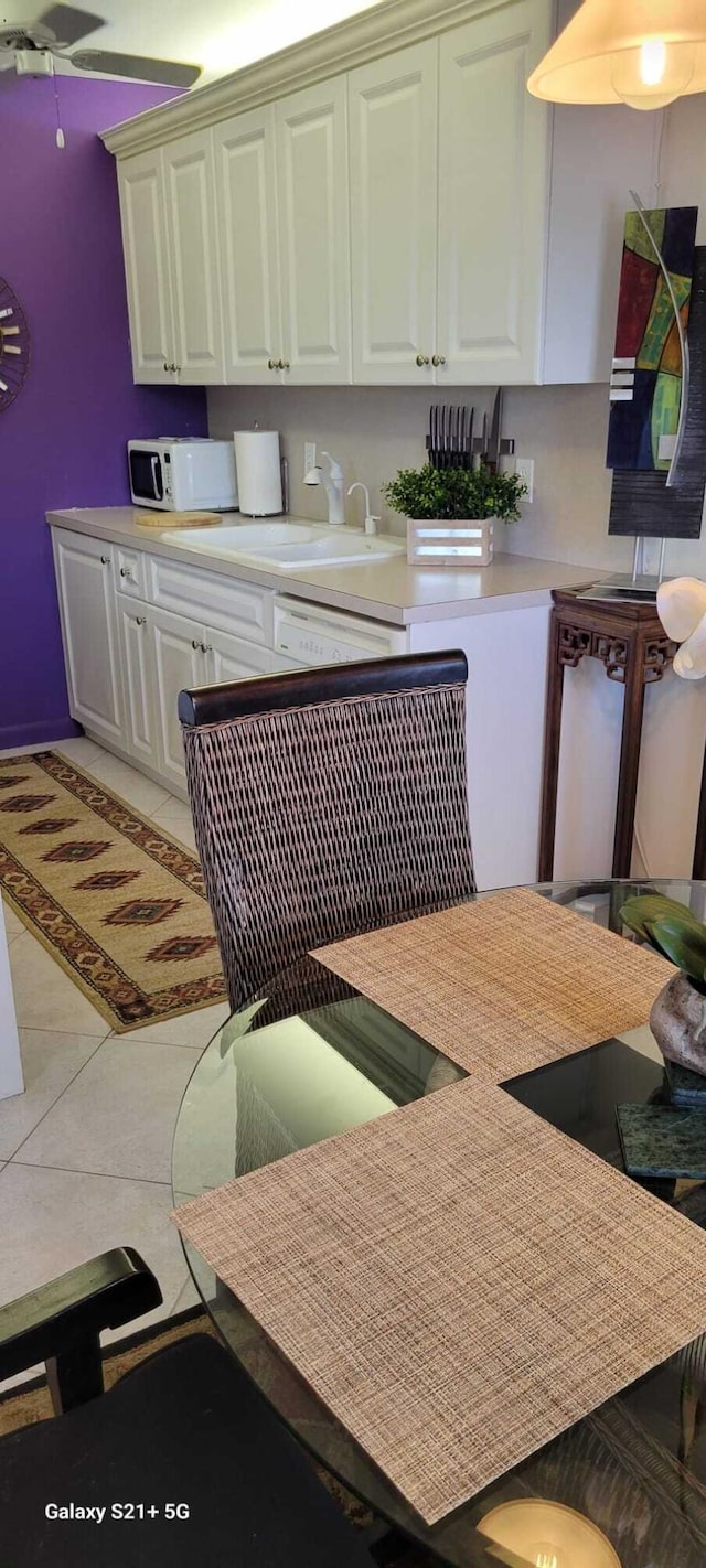 tiled dining space featuring sink