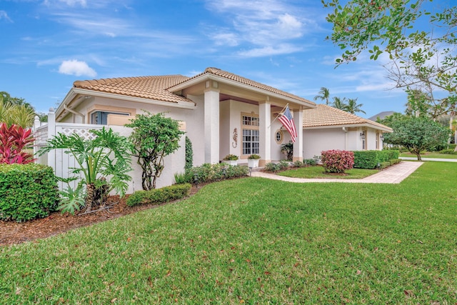 mediterranean / spanish-style house featuring a front lawn