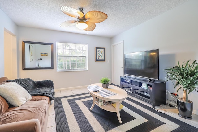 tiled living room featuring ceiling fan and a textured ceiling