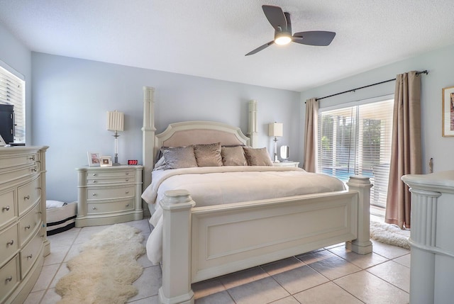 bedroom with multiple windows, a textured ceiling, ceiling fan, and light tile patterned flooring