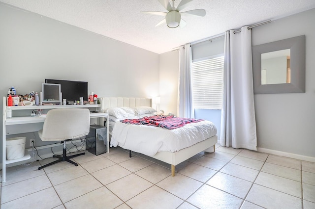 tiled bedroom featuring a textured ceiling and ceiling fan