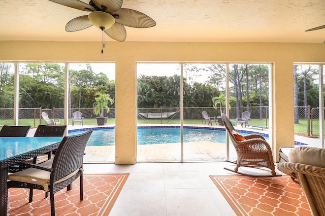 sunroom featuring ceiling fan