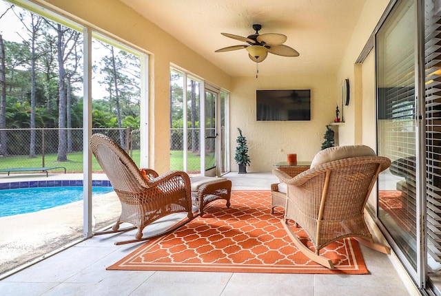 sunroom featuring ceiling fan