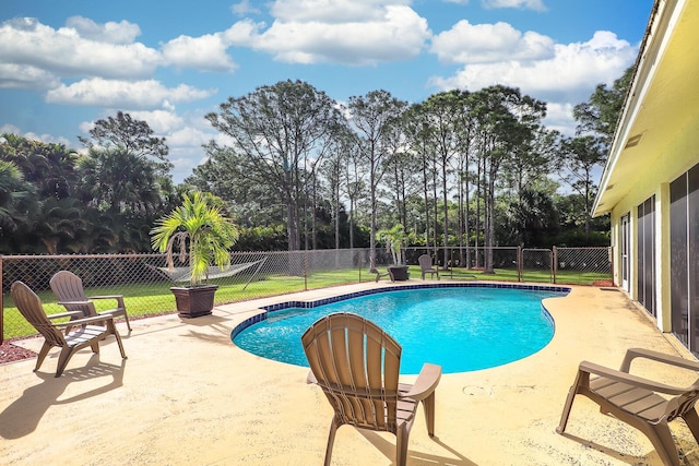 view of swimming pool with a patio and a lawn