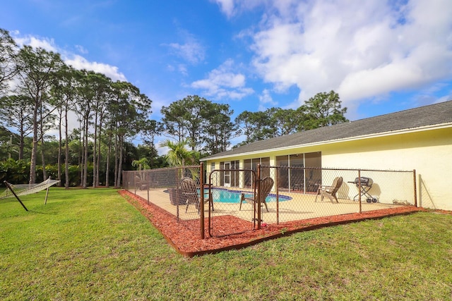 view of swimming pool featuring a patio area and a lawn