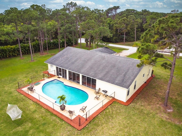 view of swimming pool with a yard and a patio area