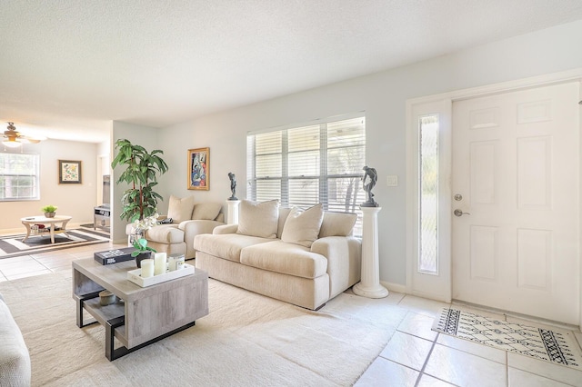 living room with light tile patterned floors and a textured ceiling