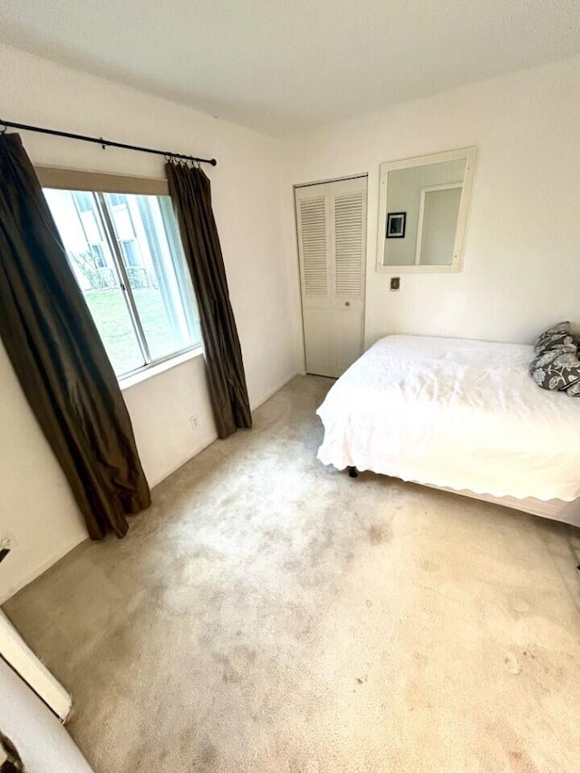 carpeted bedroom with a closet