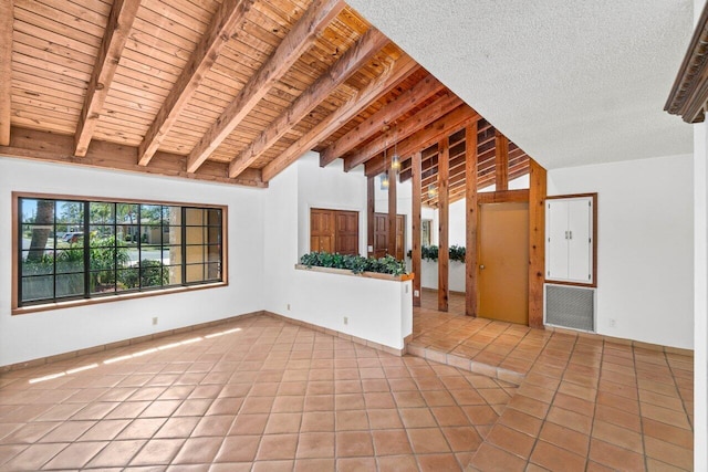 unfurnished room with light tile patterned flooring, wood ceiling, vaulted ceiling with beams, and a textured ceiling