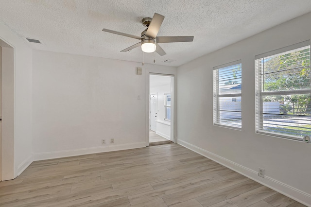 empty room featuring ceiling fan and light hardwood / wood-style flooring