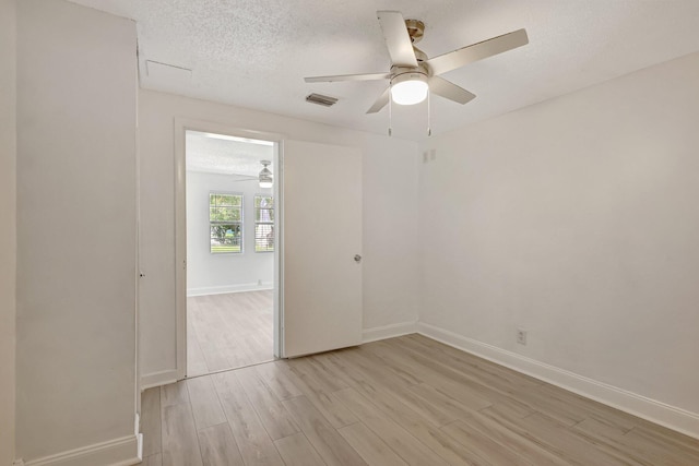 spare room featuring ceiling fan, a textured ceiling, and light hardwood / wood-style floors