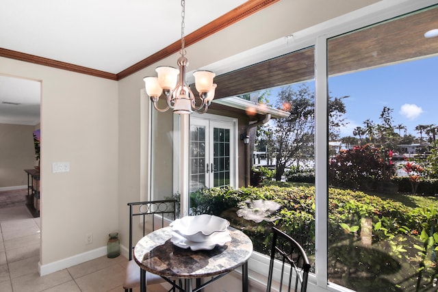 dining room with an inviting chandelier, light tile patterned floors, crown molding, and french doors