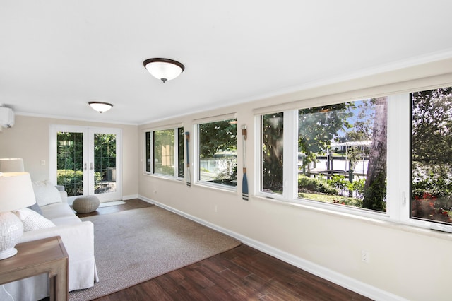 unfurnished sunroom featuring french doors and an AC wall unit