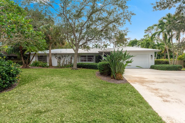 single story home with a garage and a front yard