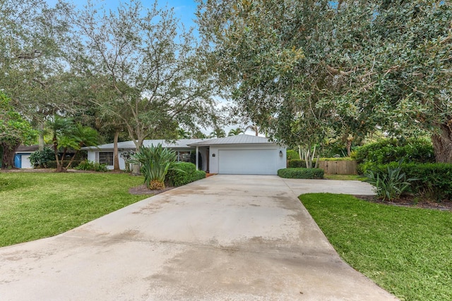 view of front of home with a garage and a front lawn