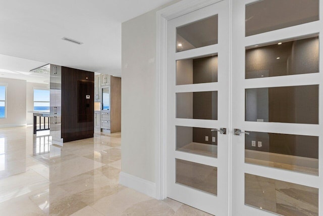 corridor featuring baseboards, visible vents, marble finish floor, french doors, and built in shelves