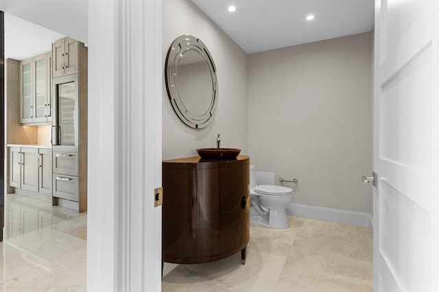 bathroom featuring recessed lighting, vanity, toilet, and baseboards