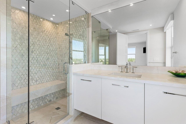 bathroom featuring a stall shower, vanity, and recessed lighting