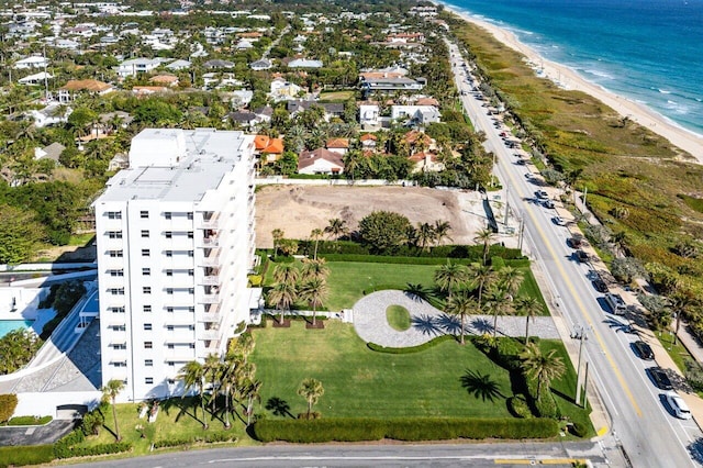 birds eye view of property with a view of the beach and a water view