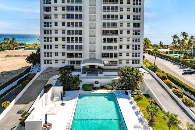 community pool featuring a patio and a water view