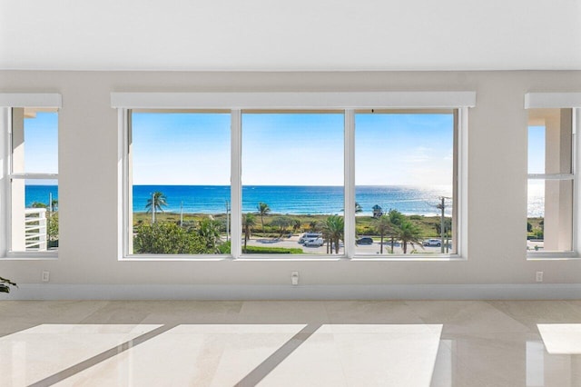 interior space with a water view and plenty of natural light