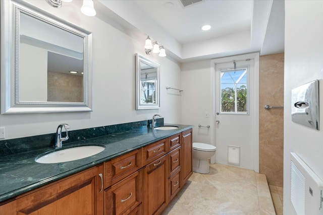 bathroom featuring tile patterned floors, vanity, and toilet