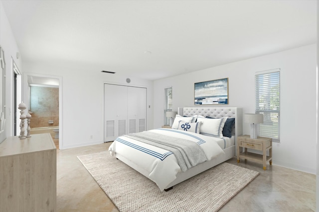 bedroom featuring ensuite bath and a closet