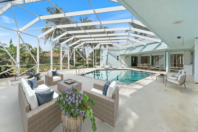 view of pool with an outdoor hangout area, a patio area, and glass enclosure