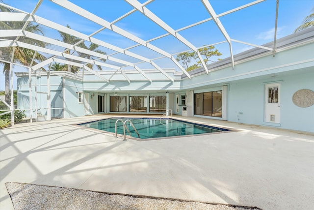 view of swimming pool with a lanai and a patio area