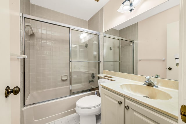 full bathroom featuring enclosed tub / shower combo, vanity, toilet, and tile patterned flooring