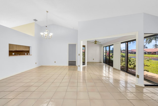 unfurnished living room with light tile patterned floors, ceiling fan with notable chandelier, and high vaulted ceiling