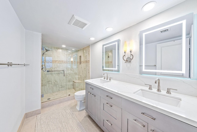 bathroom with tile patterned flooring, vanity, a shower with door, and toilet