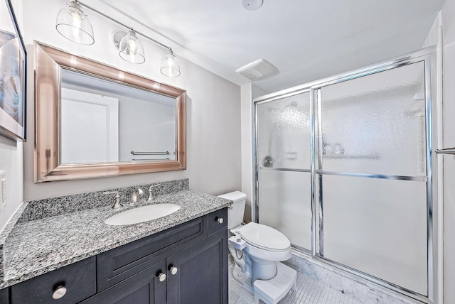 bathroom with walk in shower, vanity, and toilet