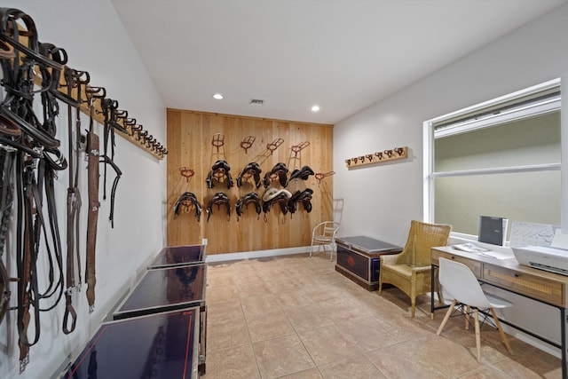 office area featuring light tile patterned floors and wooden walls