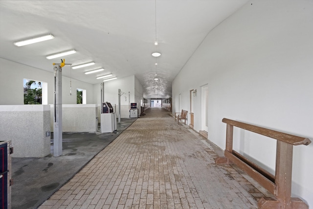 corridor featuring vaulted ceiling