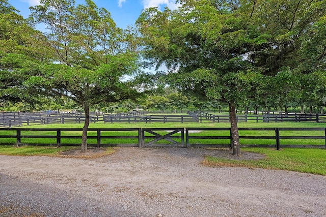 view of gate featuring a yard and a rural view