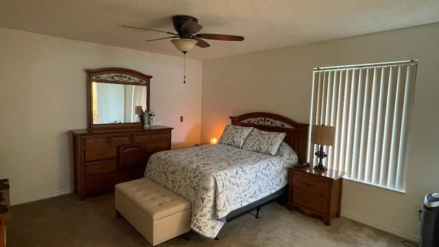 bedroom featuring ceiling fan, a textured ceiling, and carpet flooring