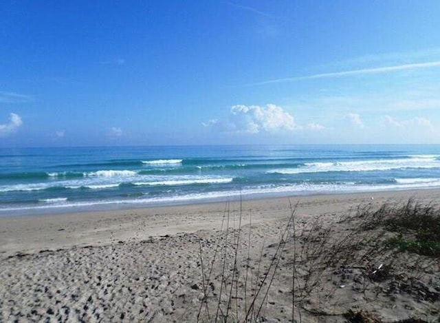 property view of water featuring a beach view