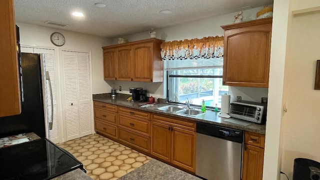 kitchen with dishwasher, range with electric cooktop, sink, and a textured ceiling